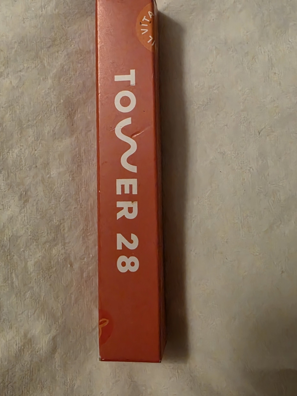 TOWER 28 Lip Product in Bright Coral-Orange Box